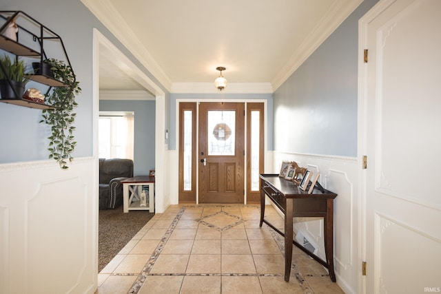 tiled foyer featuring crown molding