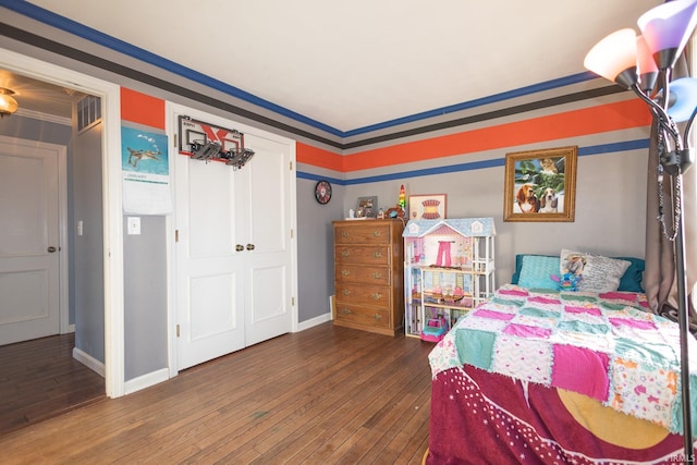 bedroom with crown molding and dark hardwood / wood-style flooring