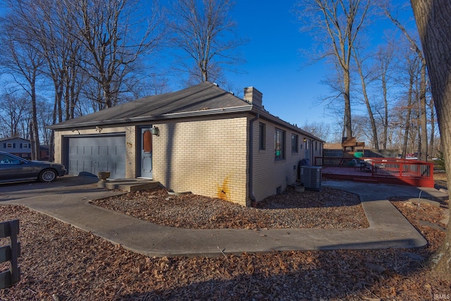 view of property exterior featuring a garage and central AC