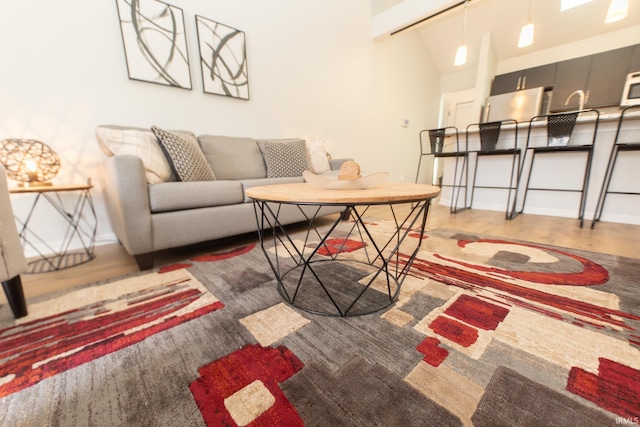 living room featuring hardwood / wood-style flooring and lofted ceiling with beams