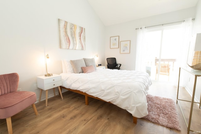 bedroom with lofted ceiling and light wood-type flooring