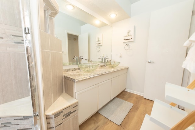 bathroom with vanity and hardwood / wood-style floors