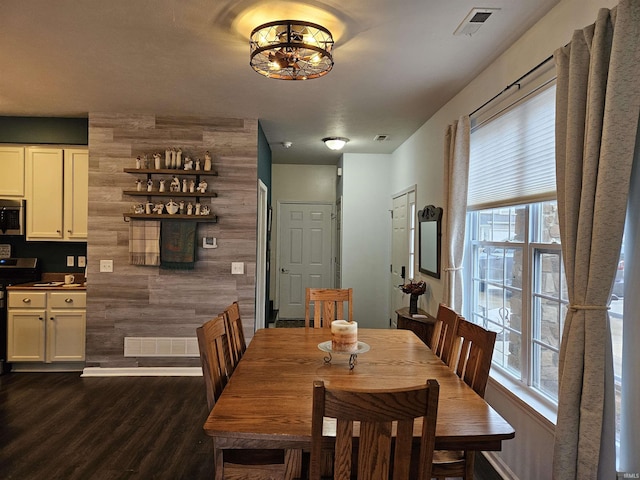 dining space featuring dark wood-type flooring and a healthy amount of sunlight