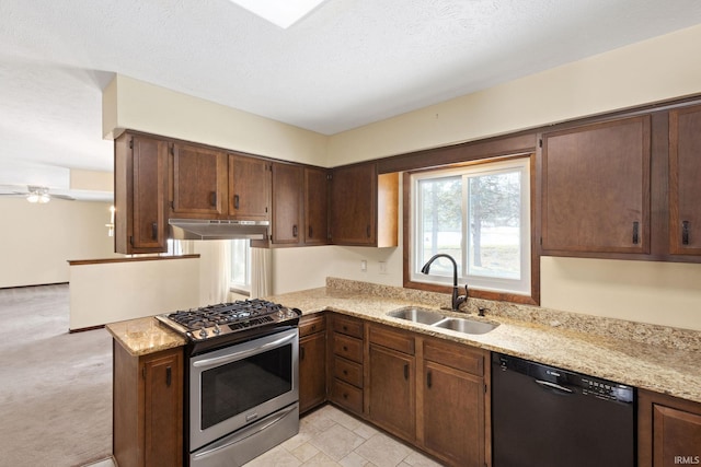 kitchen featuring stainless steel gas stove, dishwasher, sink, dark brown cabinetry, and kitchen peninsula