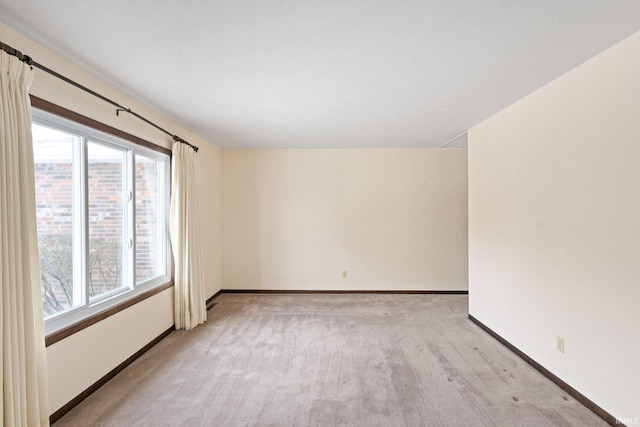 spare room featuring light colored carpet