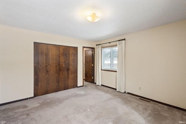 unfurnished bedroom featuring light colored carpet