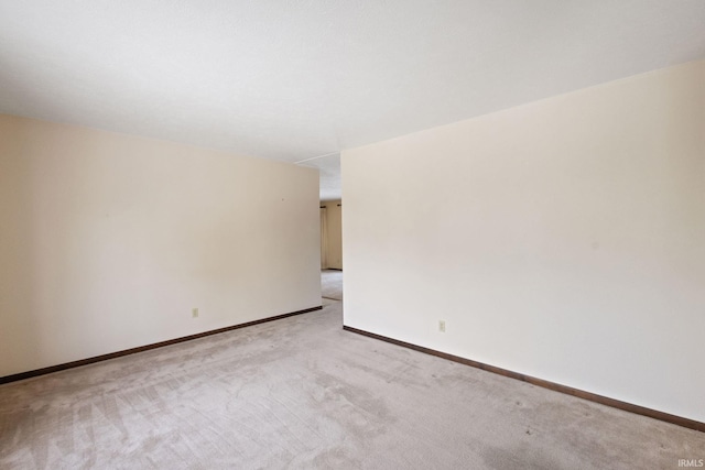 empty room featuring light carpet