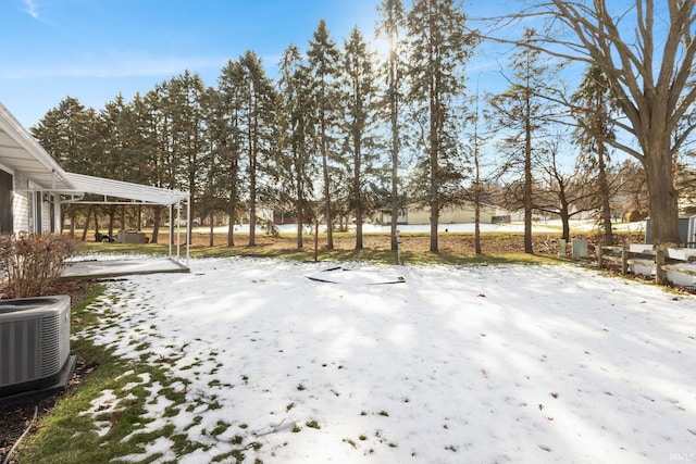 yard covered in snow with central air condition unit