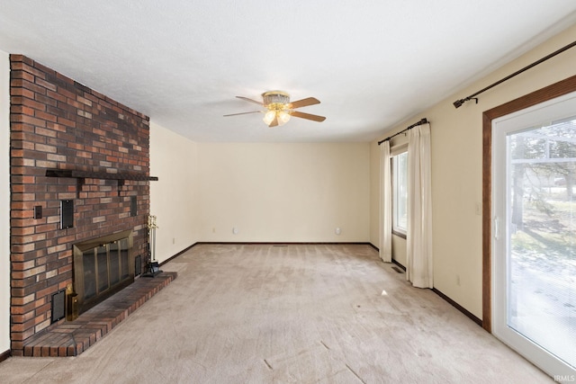 unfurnished living room with ceiling fan, light carpet, and a fireplace