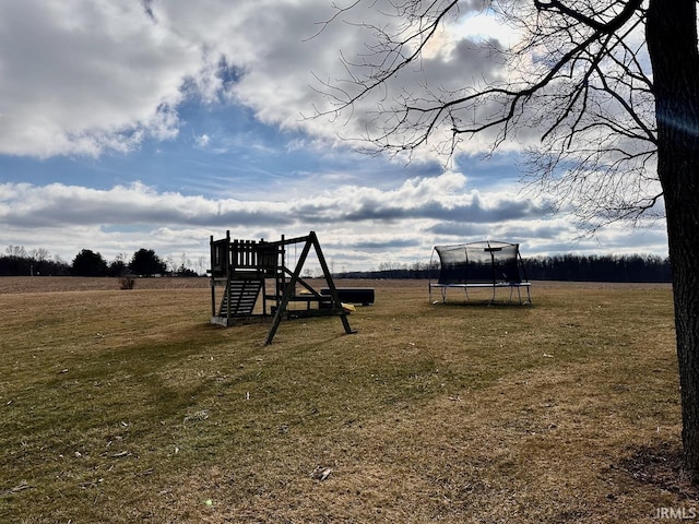 view of playground with a yard and a trampoline