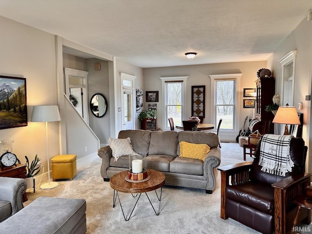 living room featuring light carpet and a textured ceiling