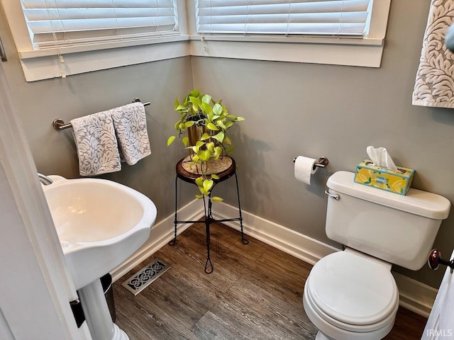 bathroom featuring toilet and hardwood / wood-style floors