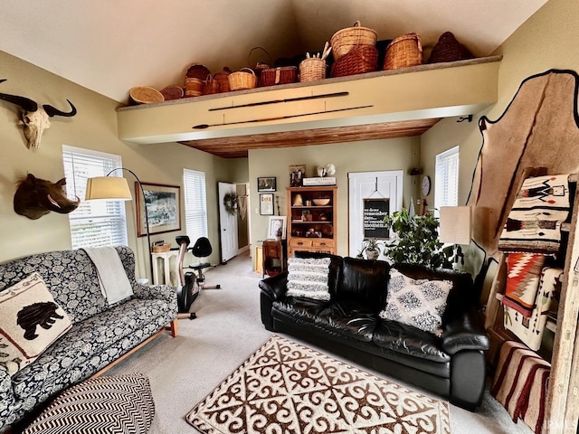 living room with lofted ceiling, a wealth of natural light, and light colored carpet