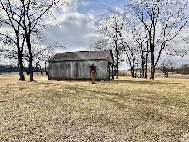 view of yard with a rural view and an outbuilding