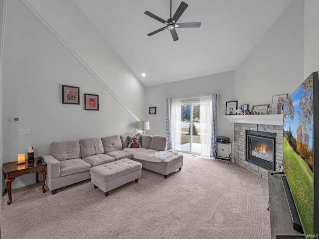 living room with ceiling fan, a stone fireplace, carpet floors, and high vaulted ceiling