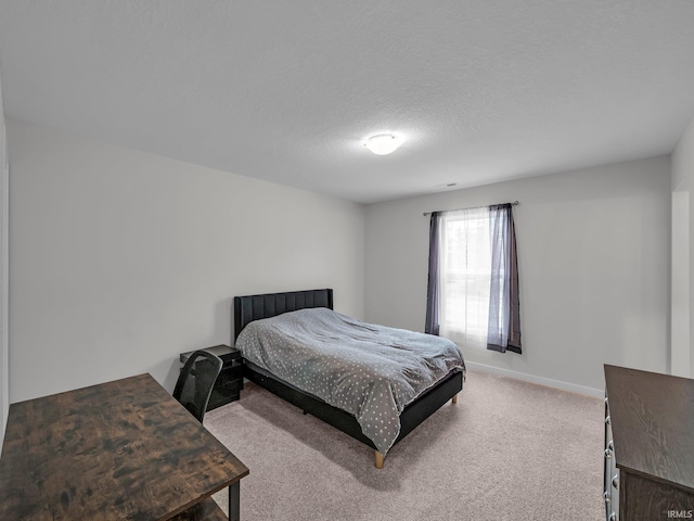 carpeted bedroom featuring a textured ceiling