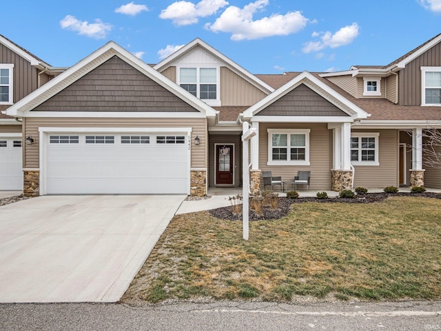 craftsman-style house featuring a garage and a front lawn