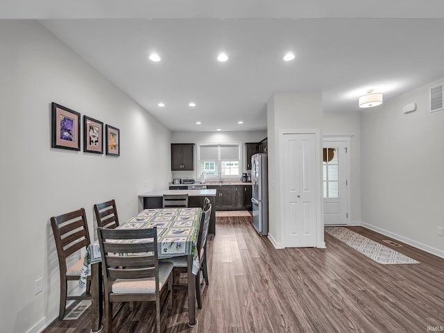 dining area with dark wood-type flooring and sink