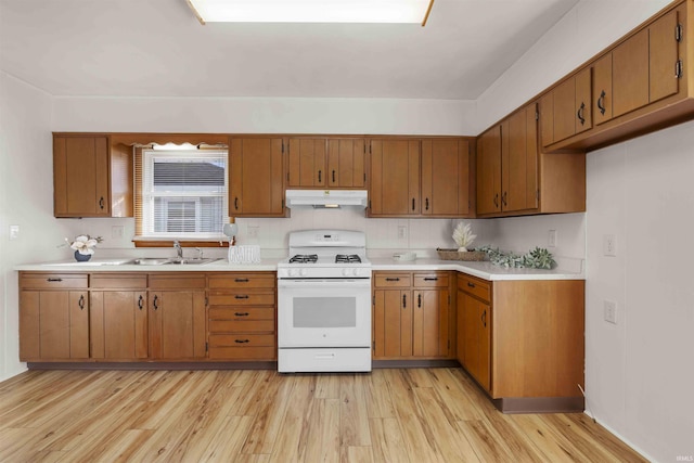 kitchen with sink, white gas stove, and light wood-type flooring