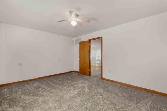 spare room featuring carpet and ceiling fan