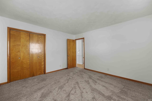 unfurnished bedroom featuring carpet and a closet