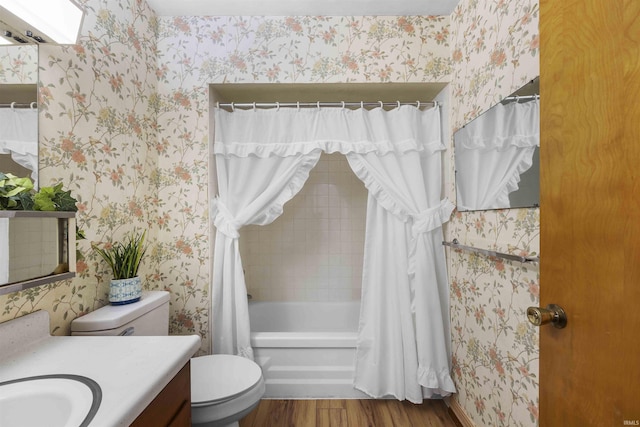 full bathroom featuring hardwood / wood-style flooring, vanity, shower / bath combo with shower curtain, and toilet