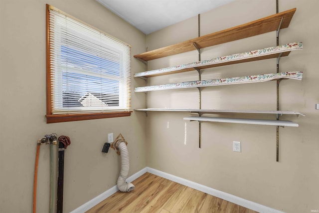 laundry area with hookup for a washing machine and light hardwood / wood-style floors