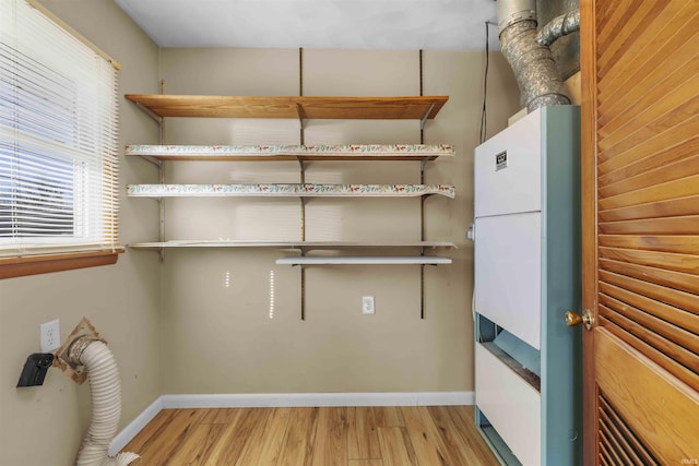 laundry room with light wood-type flooring