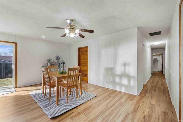 dining area with ceiling fan and light hardwood / wood-style flooring