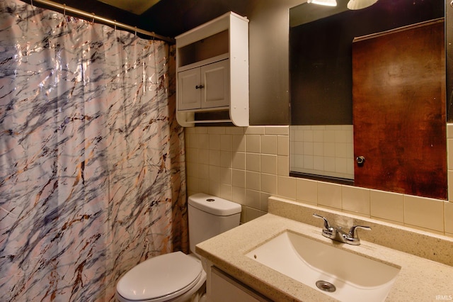 bathroom featuring vanity, toilet, a shower with shower curtain, and tile walls