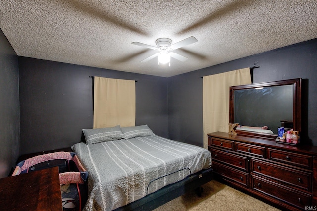 bedroom featuring light carpet, ceiling fan, and a textured ceiling