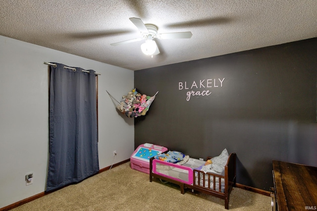 bedroom featuring ceiling fan, carpet, and a textured ceiling