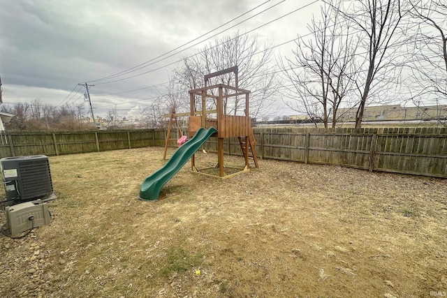 view of jungle gym with a lawn and central air condition unit