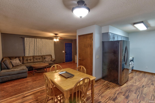 dining area featuring hardwood / wood-style floors, a textured ceiling, and ceiling fan