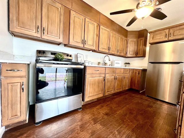 kitchen with ceiling fan, stainless steel appliances, dark hardwood / wood-style flooring, and sink