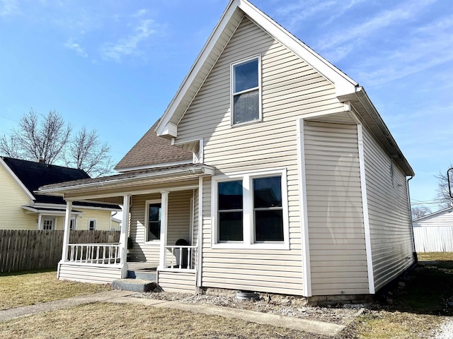 rear view of property featuring a porch