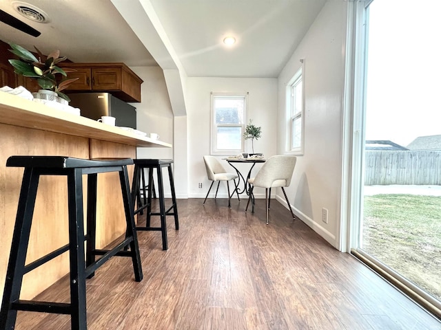 interior space with hardwood / wood-style flooring and stainless steel refrigerator