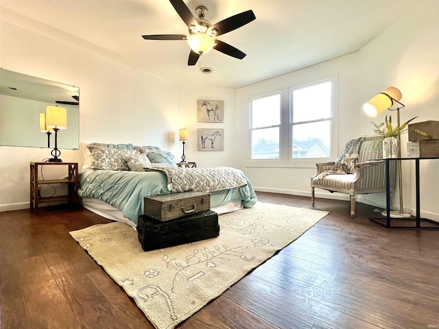 bedroom with dark hardwood / wood-style floors and ceiling fan