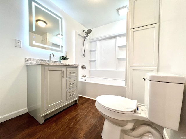 full bathroom featuring vanity, bathtub / shower combination, hardwood / wood-style floors, and toilet