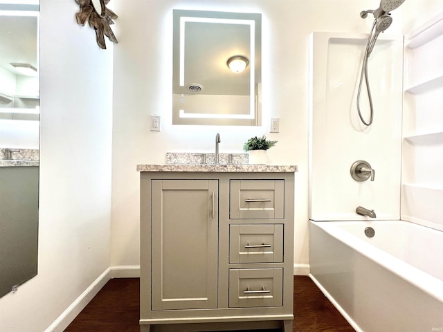 bathroom with shower / bath combination, vanity, and wood-type flooring