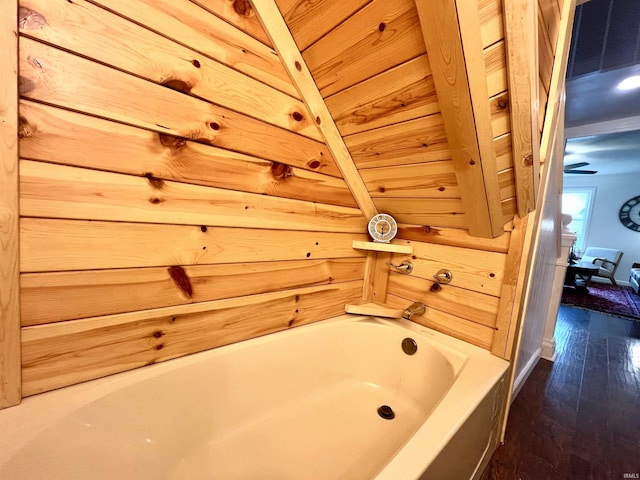 bathroom featuring hardwood / wood-style flooring and a bath