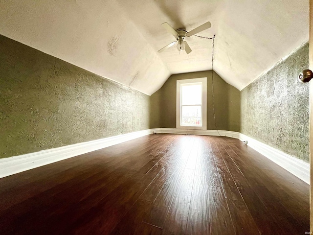 additional living space featuring hardwood / wood-style flooring, ceiling fan, and vaulted ceiling