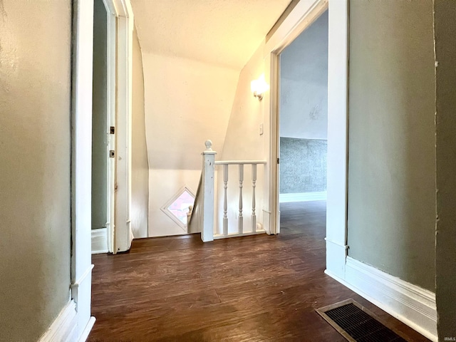 corridor with dark wood-type flooring