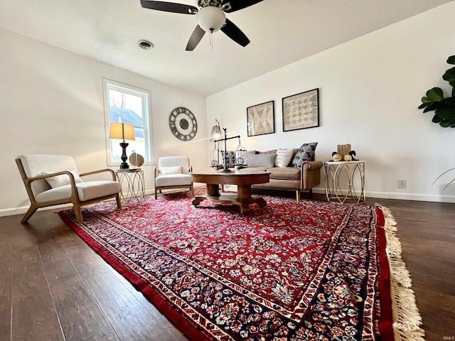 living room with dark wood-type flooring and ceiling fan