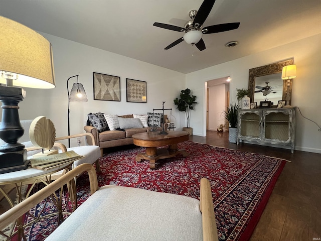 living room featuring ceiling fan and dark hardwood / wood-style flooring