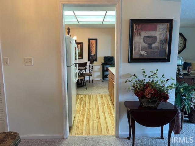 hallway featuring light colored carpet