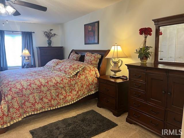 carpeted bedroom with ceiling fan