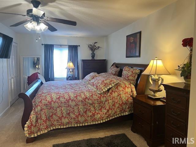 carpeted bedroom with ceiling fan