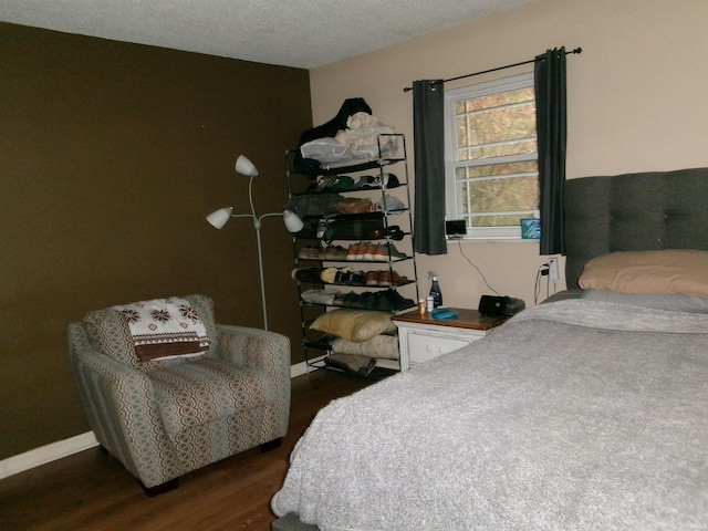 bedroom with dark hardwood / wood-style flooring