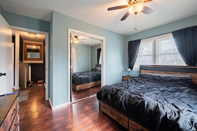 bedroom with dark hardwood / wood-style flooring, a closet, and ceiling fan